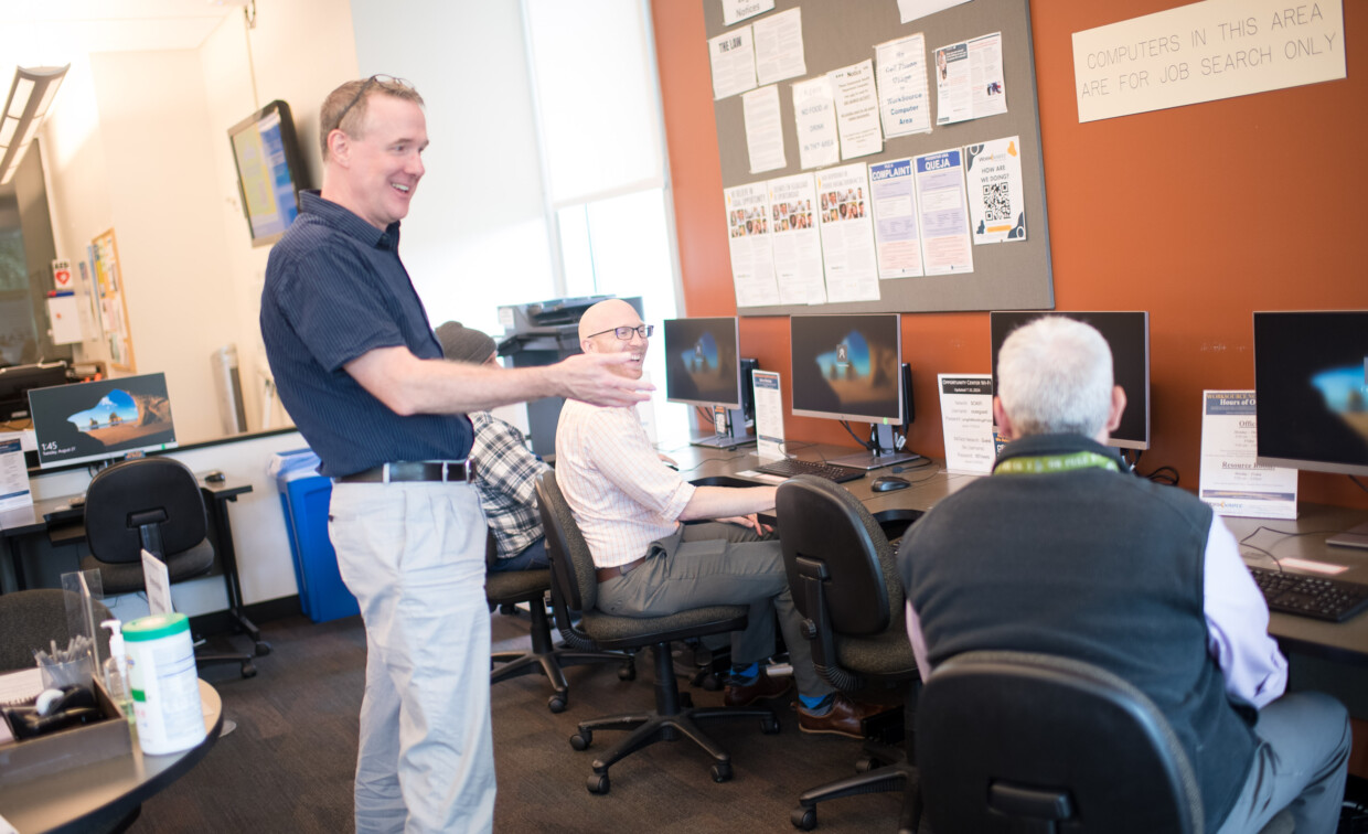 Staff helping visitors with a sign 